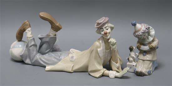A Lladro clown reclining and Lladro clown with concertina and dog